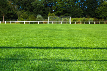 Grassy Field And Goal Post On Sunny Day
