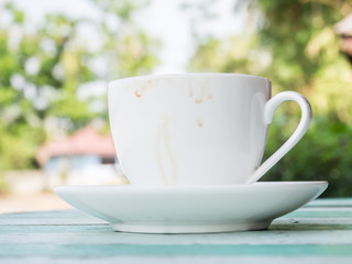 Coffee cup stains on wooden table and blurry garden background