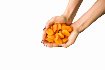 nuts and dried fruit in hands on a white background