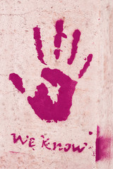 A palm print on concrete, a symbol or a sign