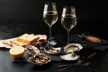 Fresh oysters with lemon and glasses of wine