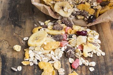 Muesli on Rustic Wooden Background.