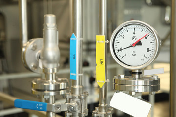 Gates, taps, monometers at the pharmaceutical plant. Open the supply of medicine to the reactor....