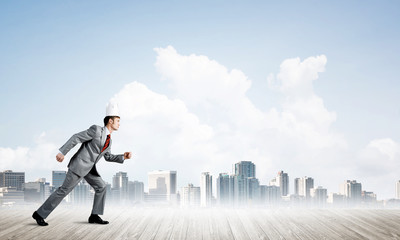 King businessman in elegant suit running and modern cityscape at background