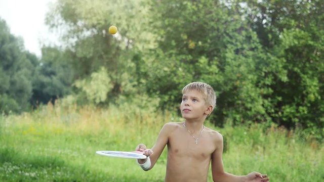Young boy playing racket ball in outdoor in slow motion. 1920x1080