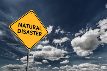 Dark blue cloudy sky and yellow road sign