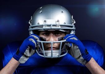 American football player adjusting his helmet