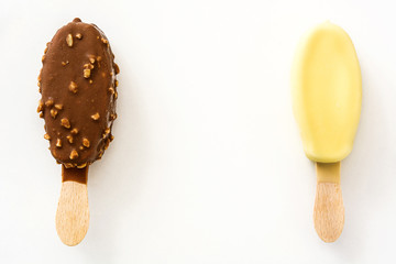 Chocolate ice cream popsicles isolated on white background. Copyspace.
