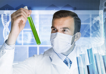 Portrait of concentrated male scientist working with reagents in laboratory