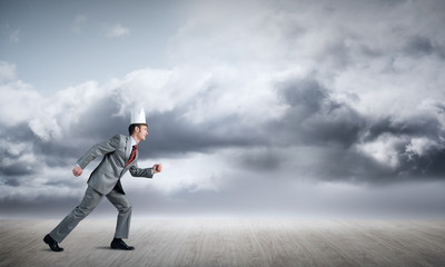 King businessman in elegant suit running and blue sky at background