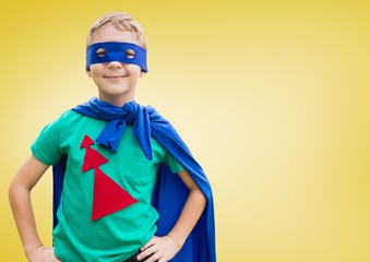 Boy in superhero costume standing with his hands on his waist