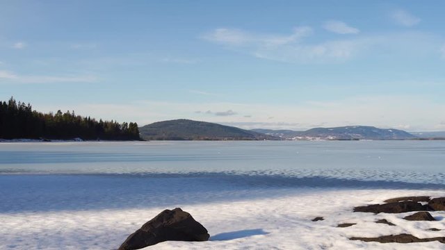 Rocks on the frozen Storsjoen lake, Norway, winter