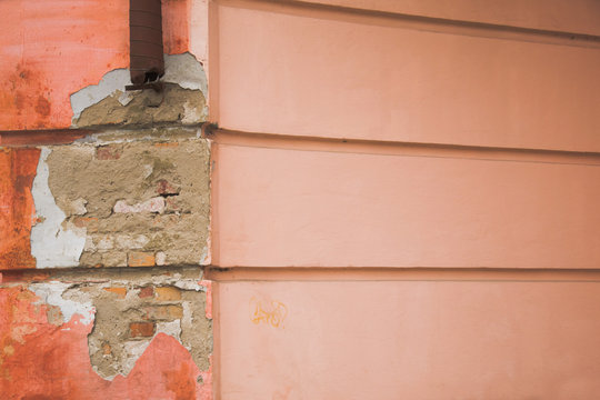 Ruined wall with parallel lines a piece of drainpipe