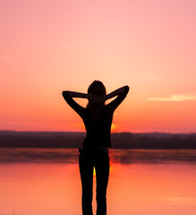 Happy Carefree Woman Enjoying Beautiful Sunset on the Beach