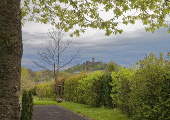 Breathtaking view of the picturesque castle, standing on a hill on a background of blue sky