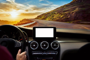 Man driving car on highway through the mountain in sunset