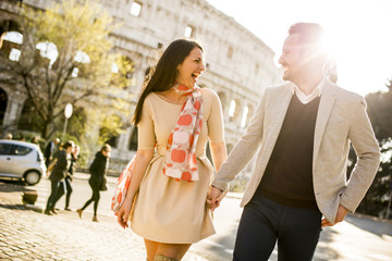 Loving couple in front of the Colosseum in Rome, Italy