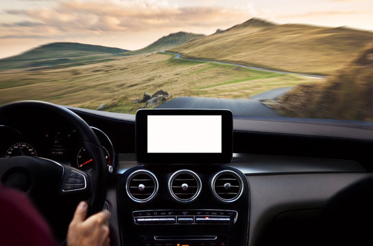 Driver’s hands on steering wheel while driving through mountains