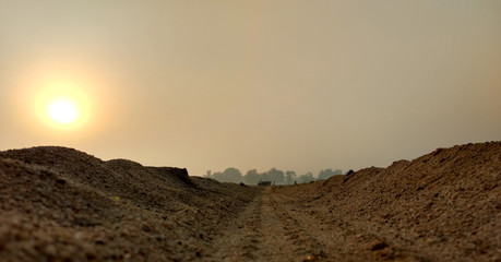 tractor way with sunrise