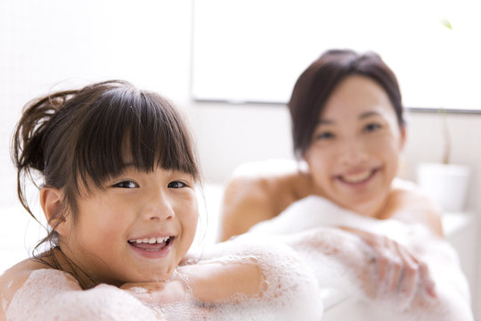 Mother and daughter in bubble bath