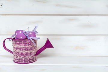 easter eggs in small purple watering can