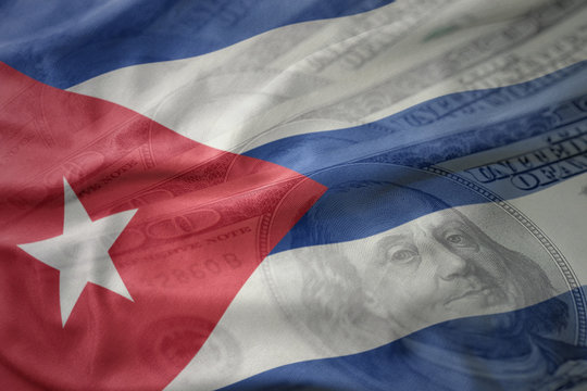 colorful waving national flag of cuba on a american dollar money background. finance concept