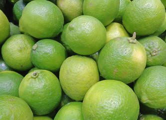 Closed up Heap of Bright Green Ripe Limes with Stem,  Background, Banner, Texture