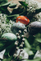 easter eggs with lilac flowers on rustic background and pussy willow. greeting card concept. colorful decorated egg with floral and chicken ornaments. spring holiday. happy easter
