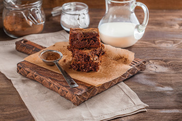 brownie with milk on a dark wooden background