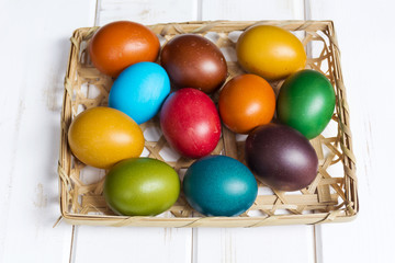 Easter eggs in the basket  on  wooden background
