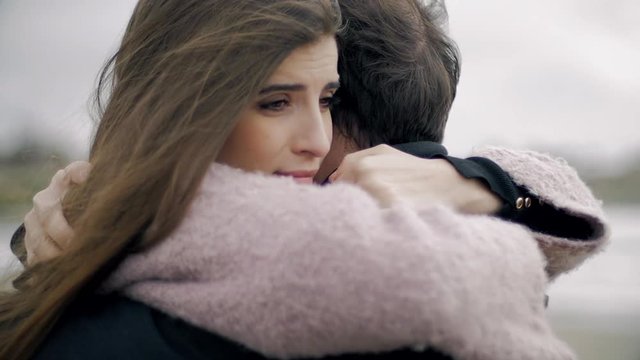 Woman hugging boyfriend feeling sad in love
