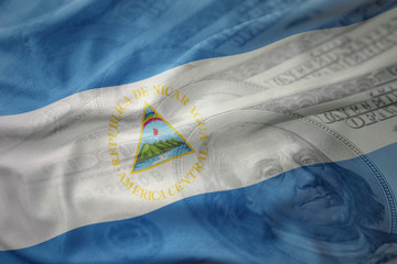 colorful waving national flag of nicaragua on a american dollar money background. finance concept