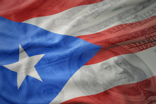 colorful waving national flag of puerto rico on a american dollar money background. finance concept