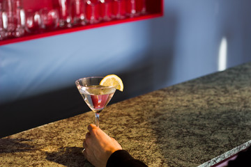 Martini at Bar with Lemon and Hand