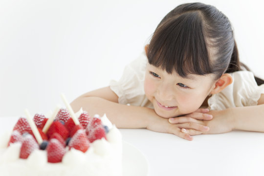 A girl Looking at a cake