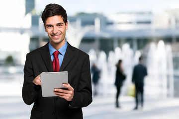 Handsome man using his tablet computer