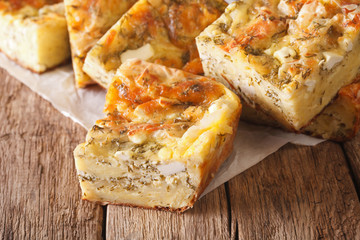 Serbian food: sliced pie Gibanica with cheese, eggs and greens close-up. horizontal