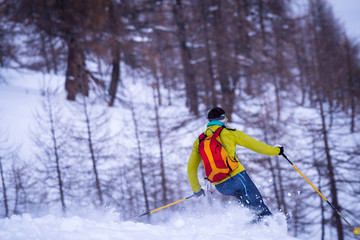 Naklejka na ściany i meble Skier skiing on snowy slope