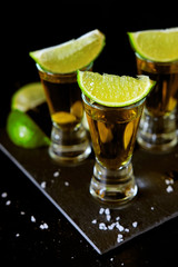 Strong alcohol drinks. Tequila shots with salt and lime slices.