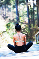 Fototapeta premium Woman stretching doing yoga in sports bra
