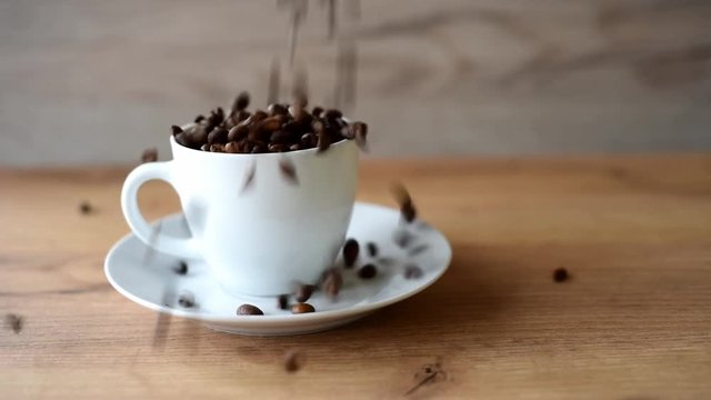 coffee cup filled by coffee beans