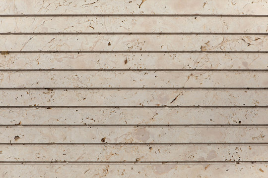 Glassed stone machined with parallel grooves.