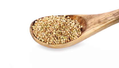 Buckwheat in wooden spoon, isolated on white background