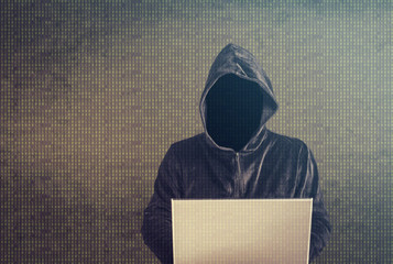 Hacker with laptop. Cyber attack and data security concept