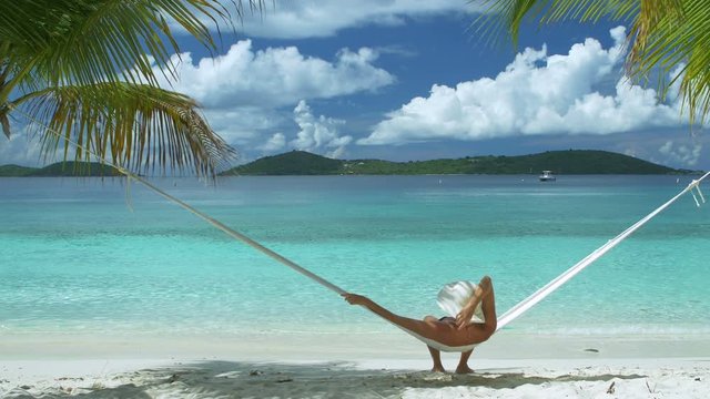 video of a woman relaxing in hammock on perfect tropical beach