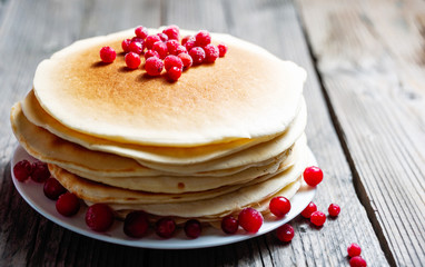 Pancake with fresh berries. Cranberry, cowberry. Gourmet Breakfast.