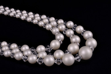 White pearls luxury necklace on black background