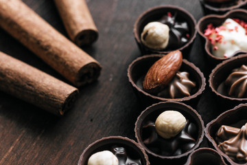Dessert candy bar with  chocolate sweets on wooden brown dark background. 