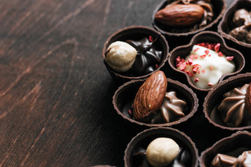 Dessert candy bar with  chocolate sweets on wooden brown dark background. 