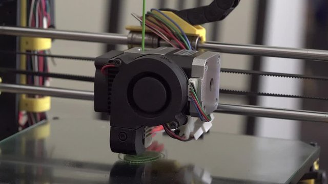 3D printer at work. 3D printing, additive manufacturing (AM), refers to processes used to create a three-dimensional object in which successive layers of material are formed under computer control